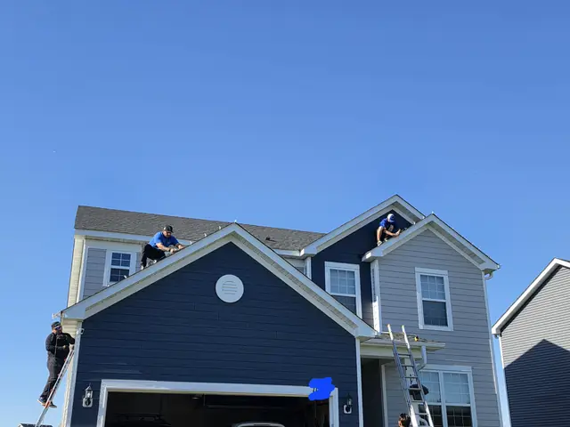 Starbrite crew installing holiday lights on the roof of a two-story home in Blaine, MN
