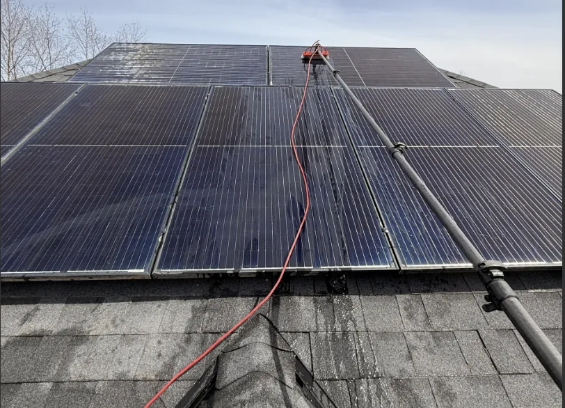 Starbrite technician cleaning rooftop solar panels